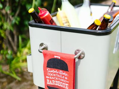 Water bottle and fitness towel on a carbon surface